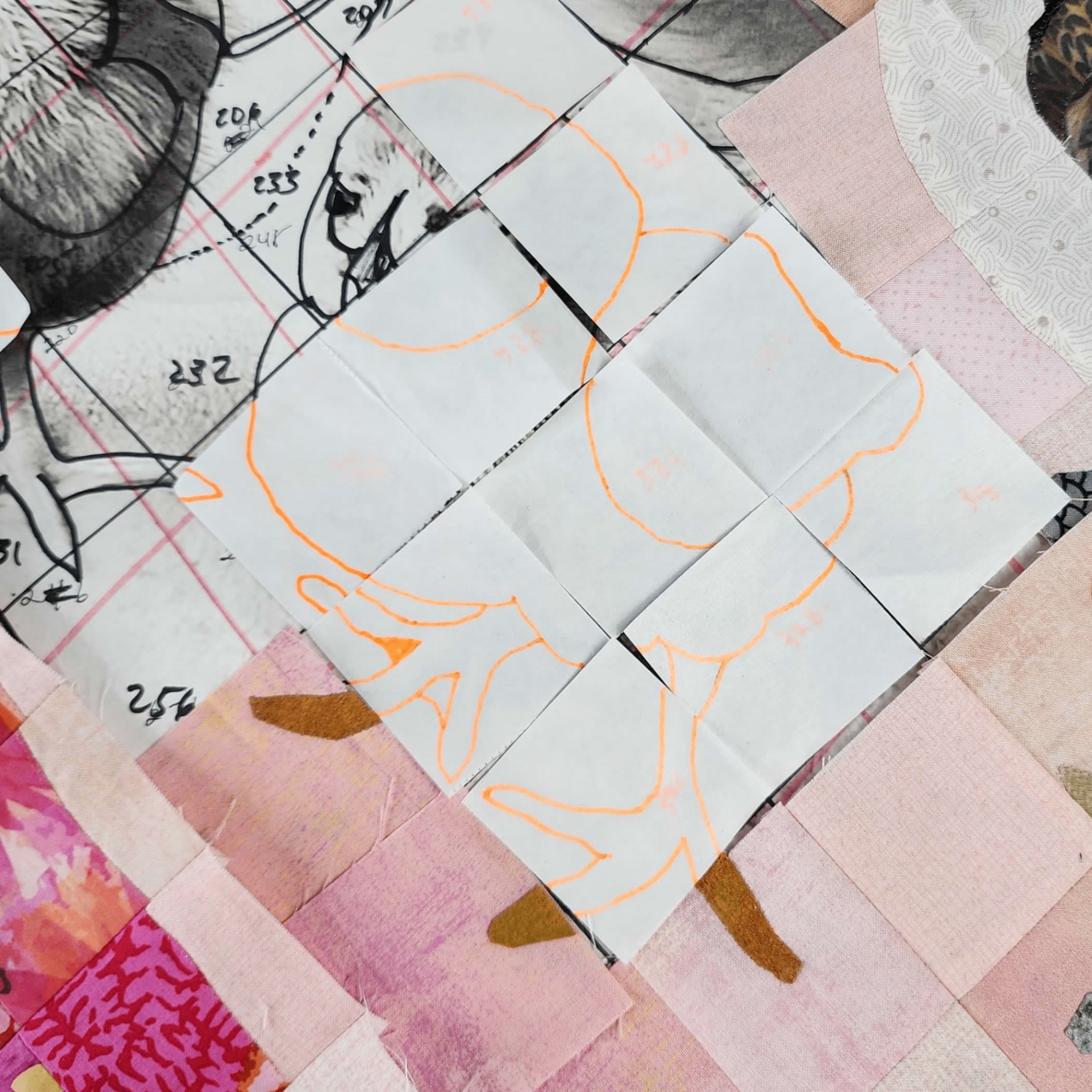 Fabric pieces arranged on a cutting mat