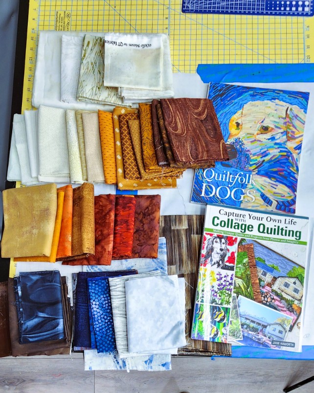 Colorful fabric swatches arranged beside collage quilting books