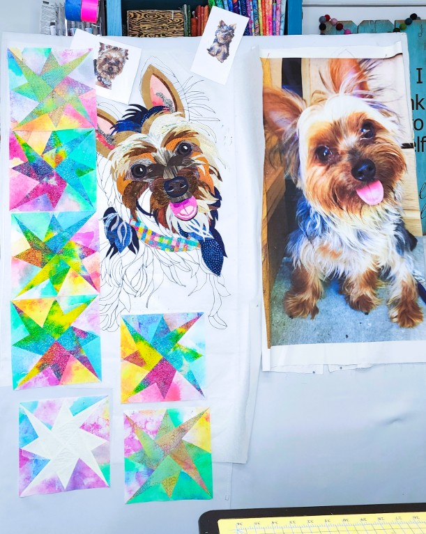 The quilt design in progress with colorful star blocks and the collage dog