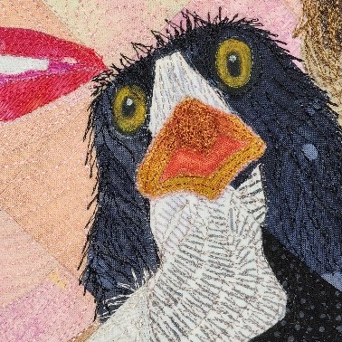 Close-up of a black chicken head on a quilt